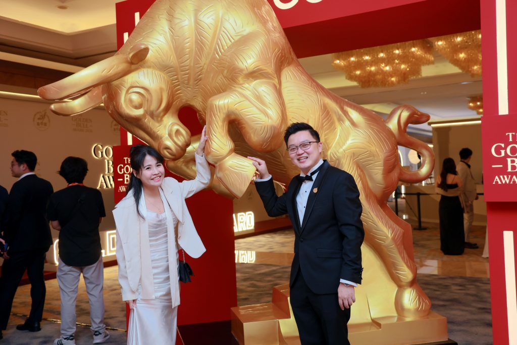 Envicion Studio team beside the golden bull statue at the Golden Bull Award 2026